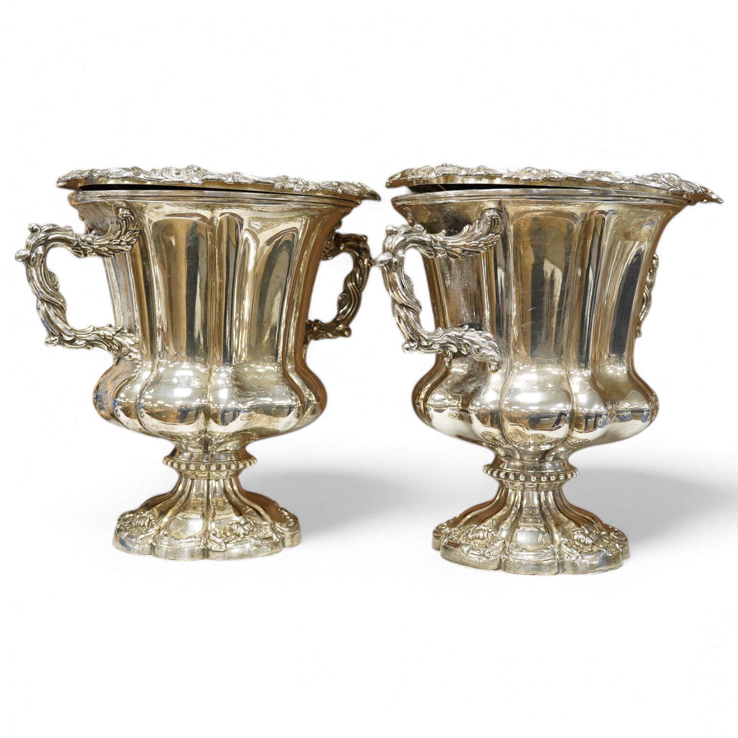 A pair of Old Sheffield plate two handled plated wine coolers, with later associated liners, 26cm high. Condition - fair